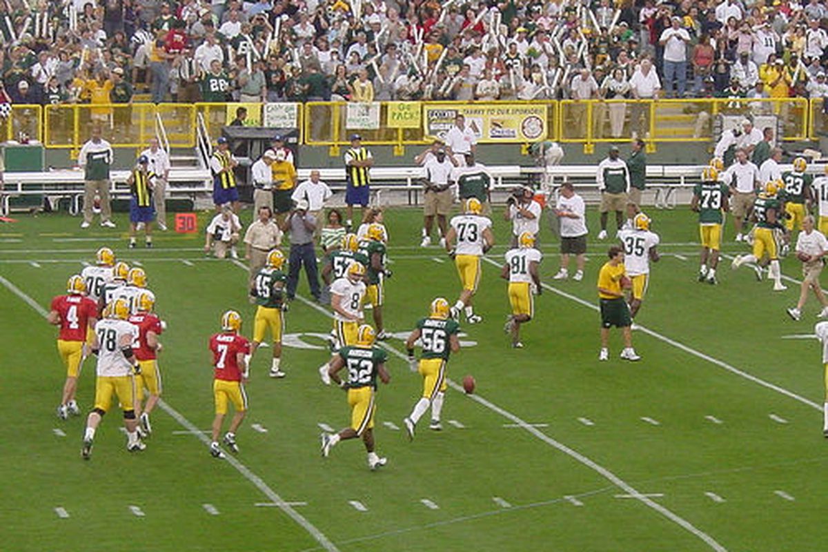 Tim Couch runs off the field as a Green Bay Packer late in his career (#2 in the center of the three red jerseys) (via <a href="http://www.flickr.com/photos/compujeramey/22102728/">compujeramey</a>)