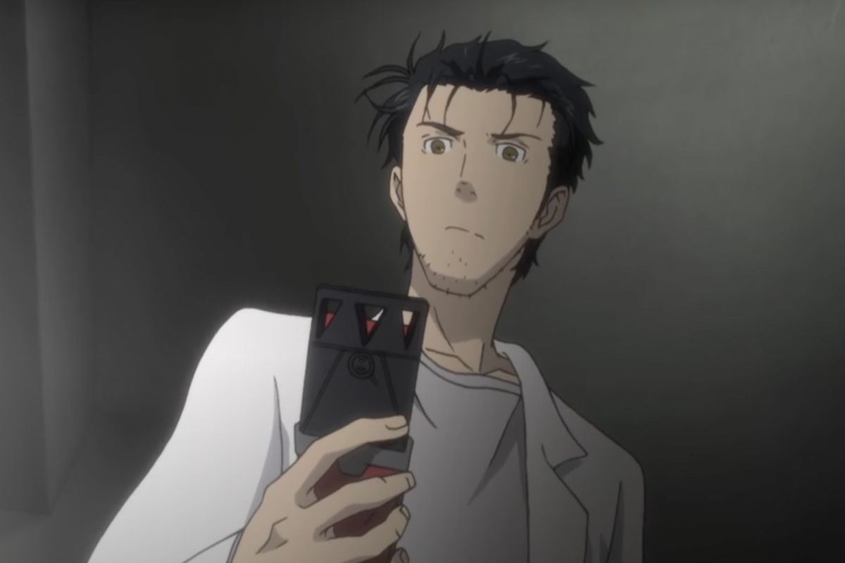 Rintaro Okabe looks down at his cell phone in Steins;Gate.