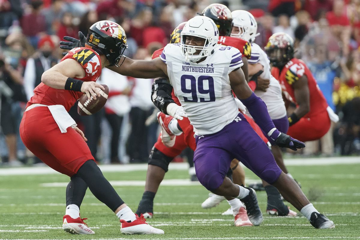 Northwestern Wildcats defensive lineman Adetomiwa Adebawore (99) goes after Maryland Terrapins quarterback Billy Edwards Jr. (9) during a Big10 football game between the Maryland Terrapins and the Northwestern Wildcats, on October 22, 2022, at SECU Stadium, in College Park, Maryland.