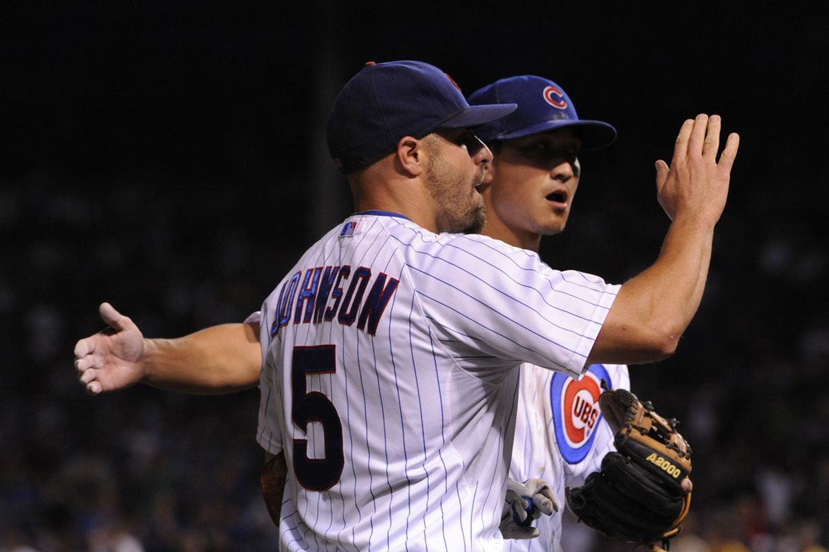Reed Johnson of the Chicago Cubs gets congratulated by Darwin Barney after making a catch against the Pittsburgh Pirates at Wrigley Field in Chicago, Illinois. (Photo by David Banks/Getty Images) 