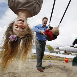 Ashley Johnson hangs upside down while playing with her dad Scott and brothers Tommy and Alex at their home in Orem Tuesday, March 29, 2016.