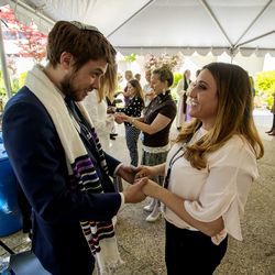 Rabbi Samuel L. Spector, of Congregation Kol Ami, talks with Krista Numbers, director of marketing at St. Mark's Hospital in Millcreek, during the 18th annual Blessing of the Hands at the hospital on Monday, May 13, 2019. The annual ceremony, featuring spiritual leaders from different denominations, recognizes hospital employees for all that they do to promote healing and provide comfort for patients throughout the year.