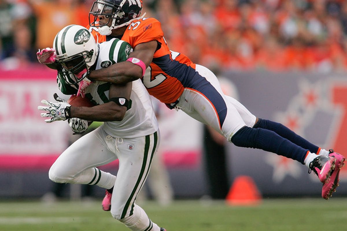 DENVER - OCTOBER 17:  Wide receiver Santonio Holmes #10 the New York Jets is tackled by cornerback Perrish Cox #32 of the Denver Broncos at INVESCO Field at Mile High on October 17 2010 in Denver Colorado.  (Photo by Justin Edmonds/Getty Images)