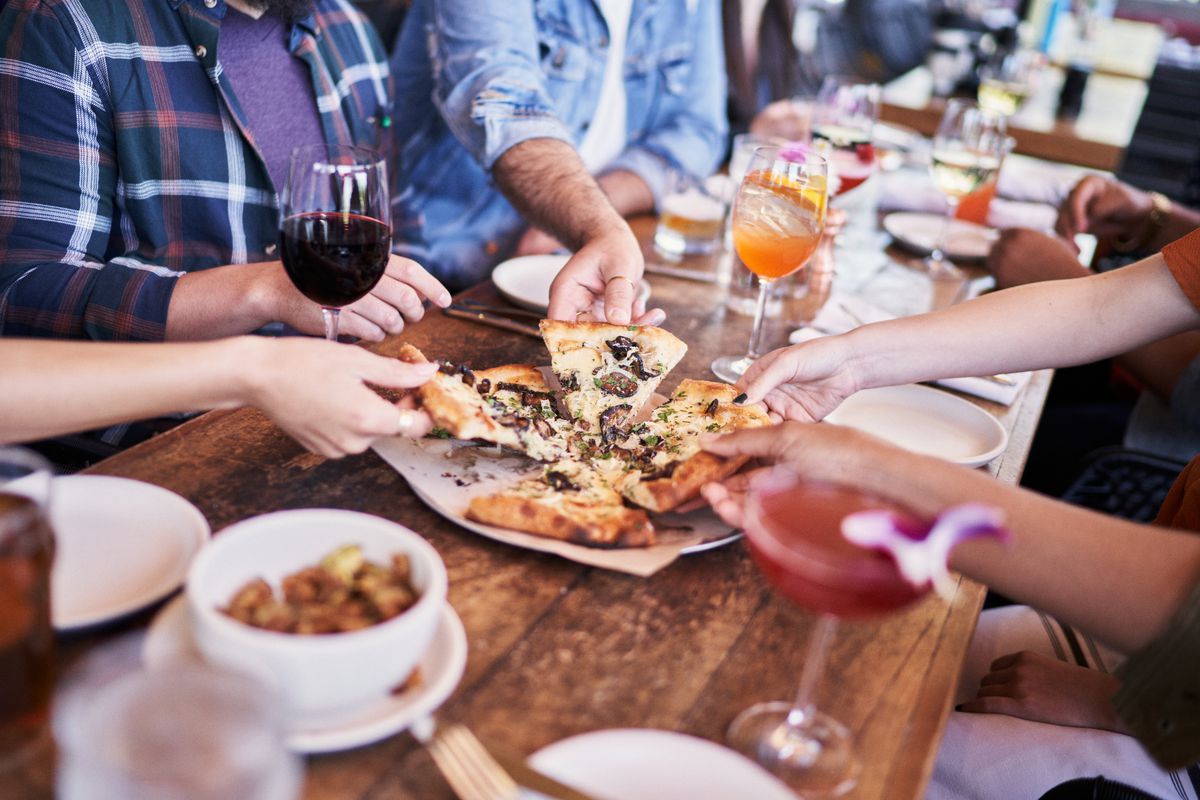 Diners feast on slices of pizza at North Italia.