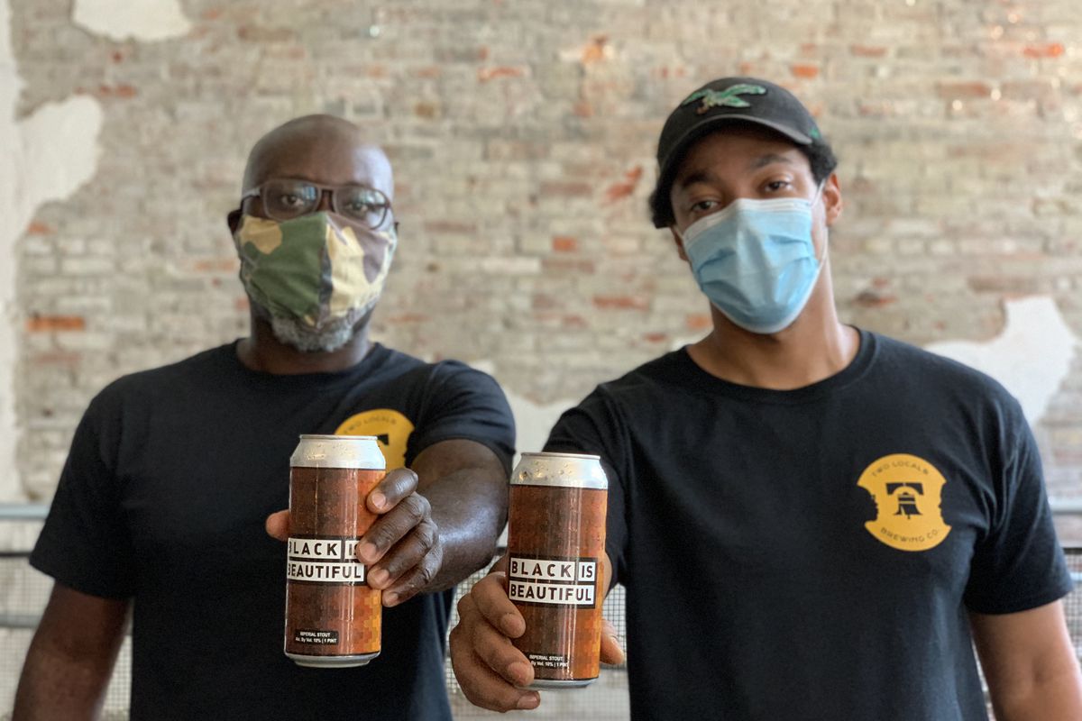two men with pandemic face masks holding cans of beer