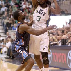 DeMarre Carroll, of the Utah Jazz, shoots around Ben Gordon, of the Charlotte Bobcats, during a basketball game at the Energy Solutions Arena in Salt Lake City on Friday, March 1, 2013. The Jazz won 98-68.