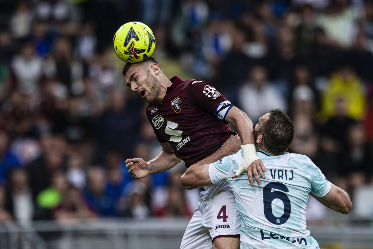 Alessandro Buongiorno (L) of Torino FC competes for a header...