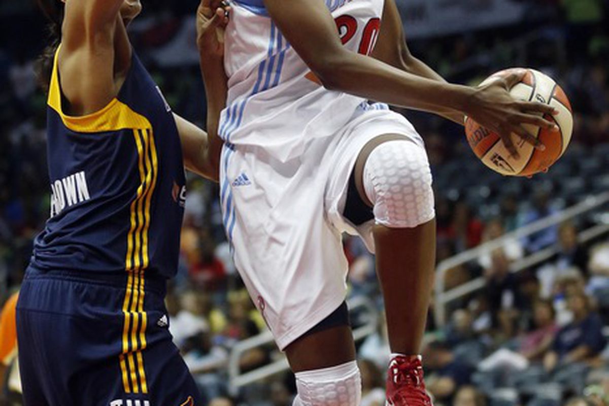 Jun 26, 2012; Atlanta, GA, USA; Atlanta Dream forward Sancho Lyttle (20) goes for a lay up past Indiana Fever center Tammy Sutton-Brown (left) during the first half at Philips Arena. Mandatory Credit: Josh D. Weiss-US PRESSWIRE