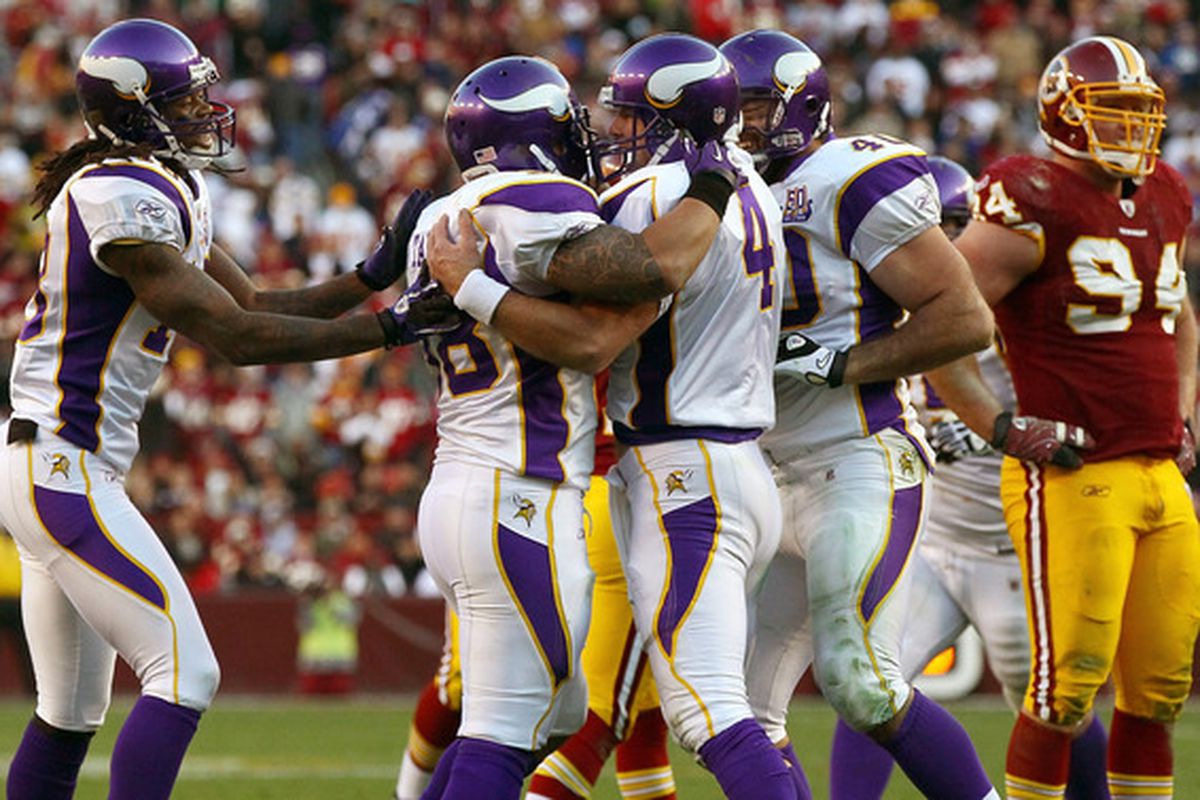 Brett Favre and his Vikings teammates celebrate him not getting killed or breaking anything else when he ran for the first down at the end of the fourth quarter to clinch a win in Sunday's game against the Washington Redskins.