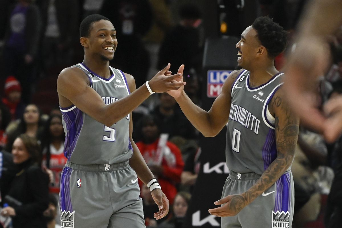 Sacramento Kings guard De’Aaron Fox (5) celebrates with guard Malik Monk (0) after Fox made a three-point basket to defeat the Chicago Bulls at the United Center.