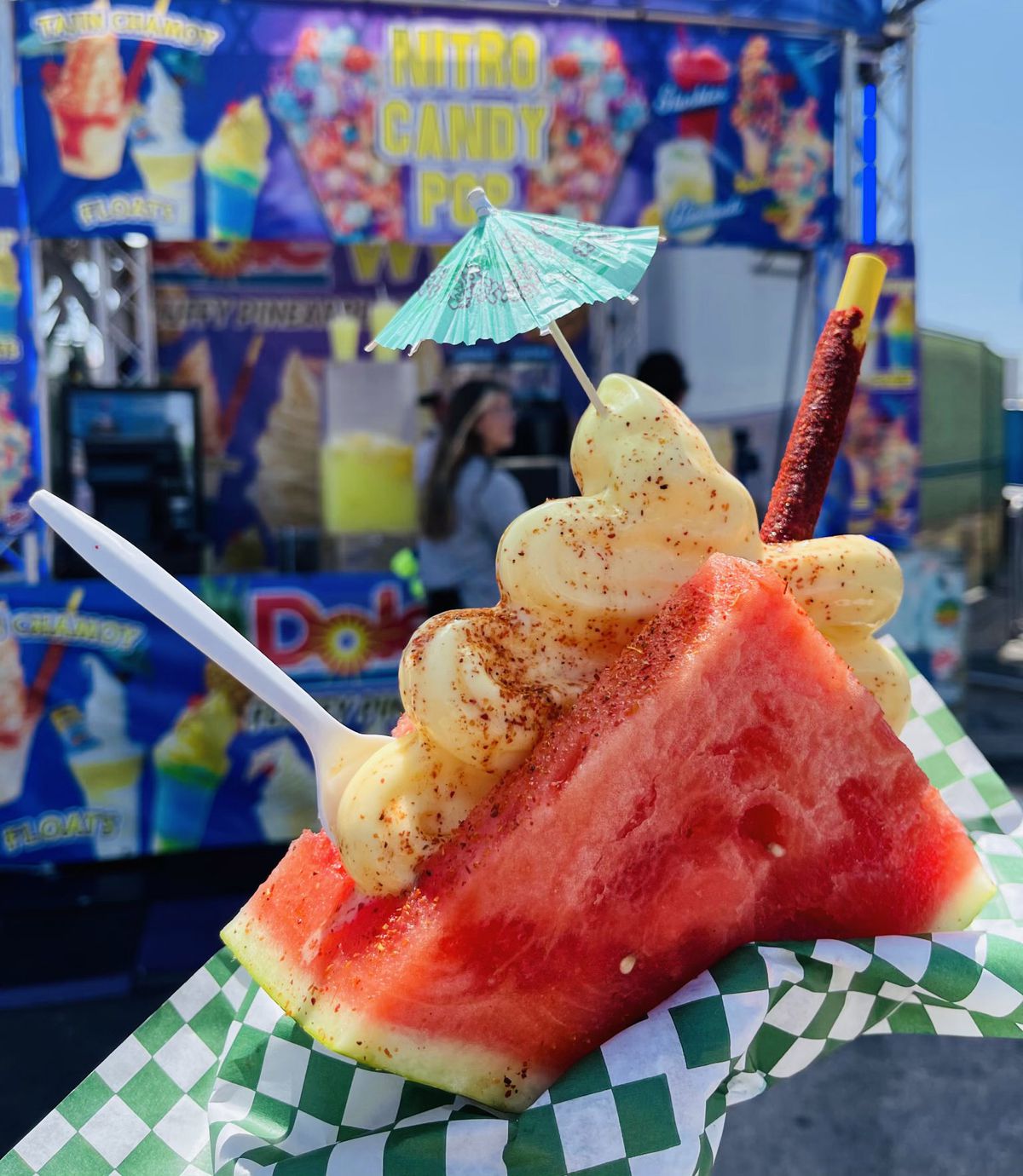 Two slices of watermelon with a mountain of Dole whip in the middle, with a small umbrella on top.