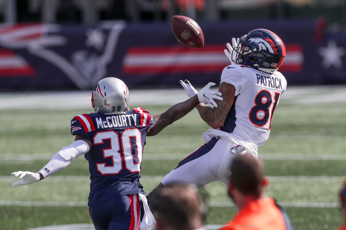 Denver Broncos receiver Tim Patrick (81) catches a pass while defended by New England Patriots cornerback Jason McCourty (30) during the first half at Gillette Stadium.