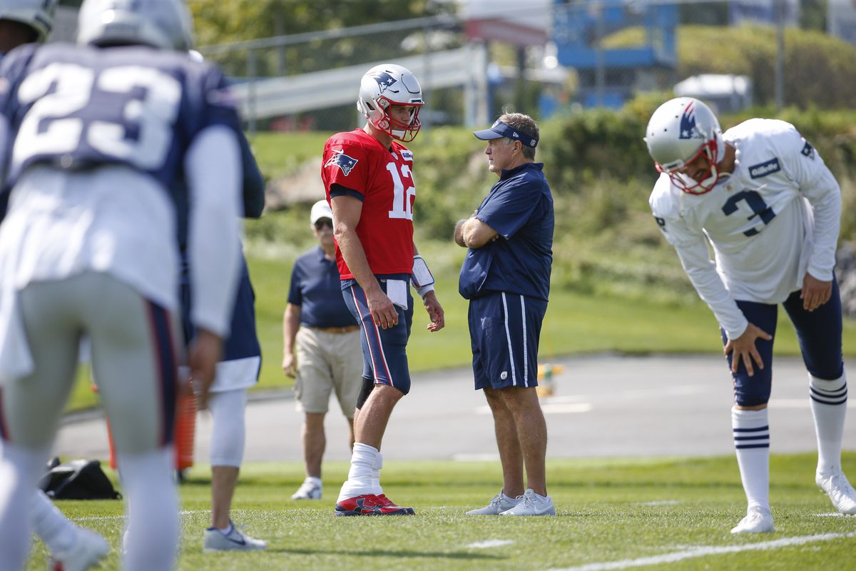 New England Patriots head coach Bill Belichick talks with quarterback Tom Brady during practice at Gillette Stadium.