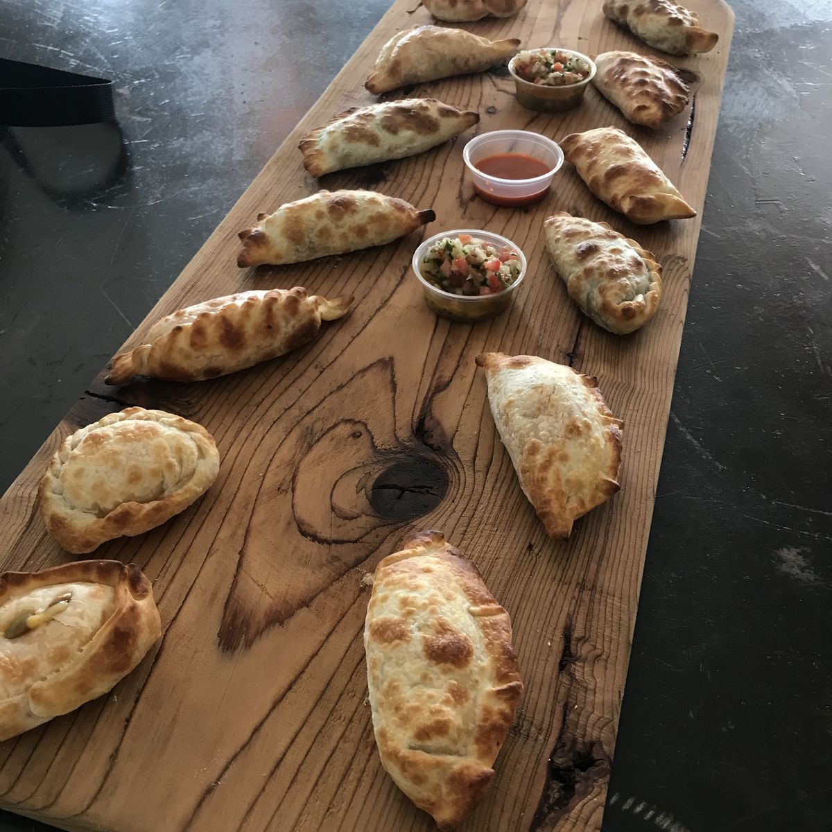 variety of empanadas on a cutting board