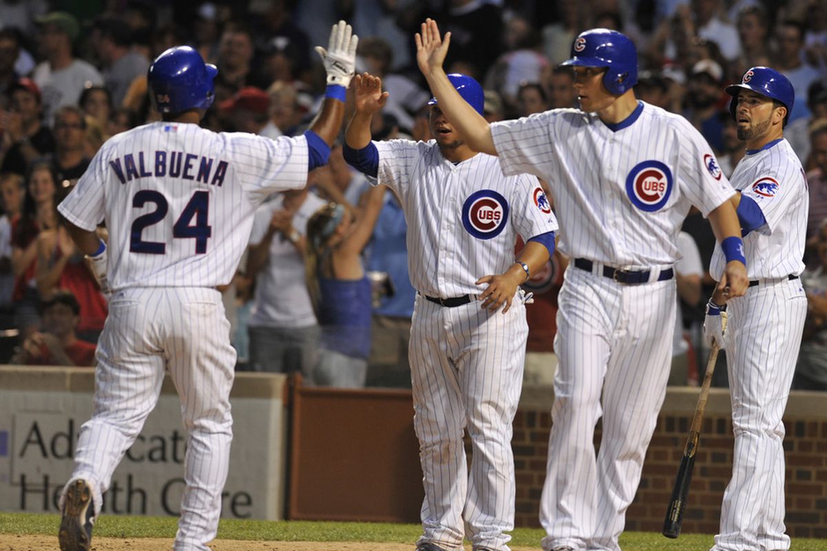 Luis Valbuena of the Chicago Cubs gets congratulated by Welington Castillo, Jeff Baker and David DeJesus after hitting a three-run homer against the Boston Red Sox at Wrigley Field in Chicago, Illinois. (Photo by David Banks/Getty Images)
