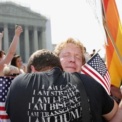 Michael Knaapen, left, and his husband John Becker, right, embrace outside the Supreme Court in Washington, Wednesday, June 26, 2013 after the court struck down a federal provision denying benefits to legally married gay couples.