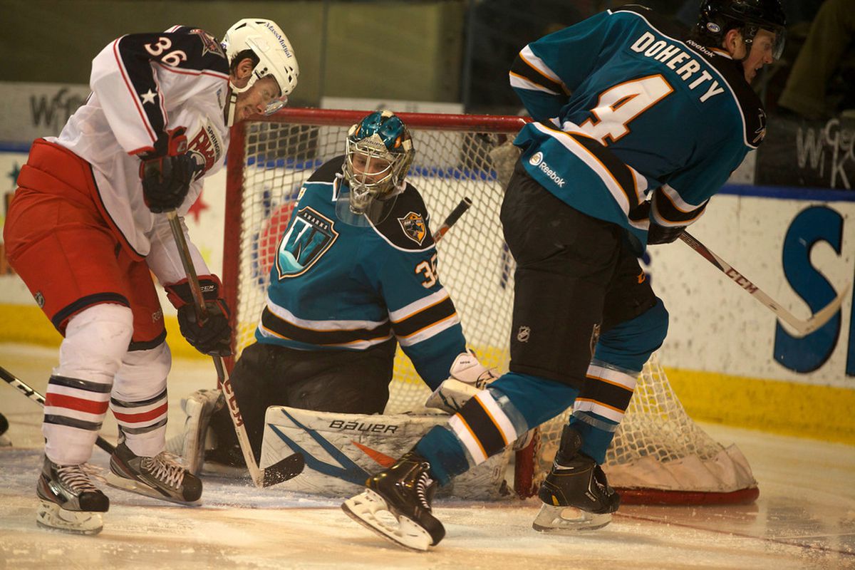 Worcester Sharks goaltender Harri Sateri makes a save on Springfield Falcons center Boone Jenner during Wednesday night's game at the DCU Center.