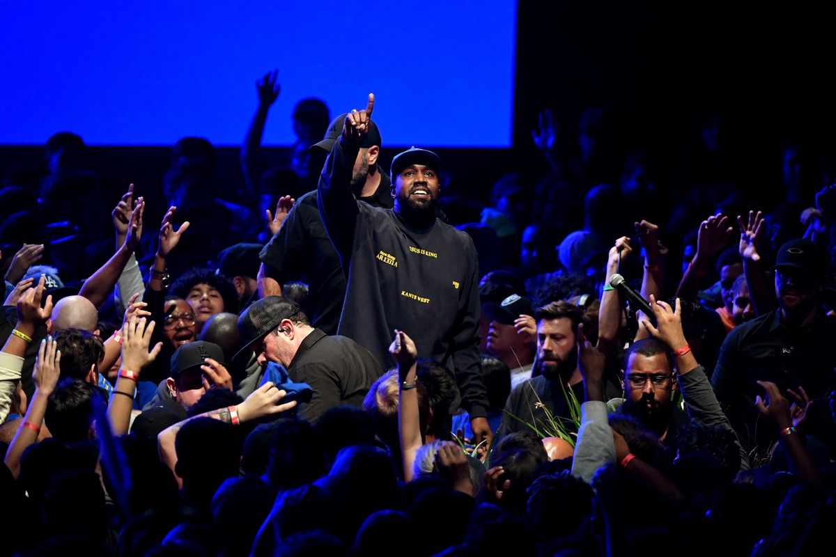 Rapper Kanye West performs amid a crowd of fans at a performance in Southern California.