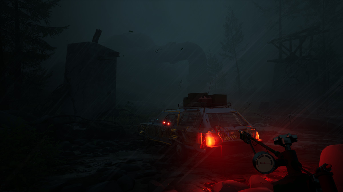 A gloomy, rain-lashed nighttime first-person view of a station wagon with lashed-together panels and homebrew modifications. In the foreground the player is holding some kind of nozzle