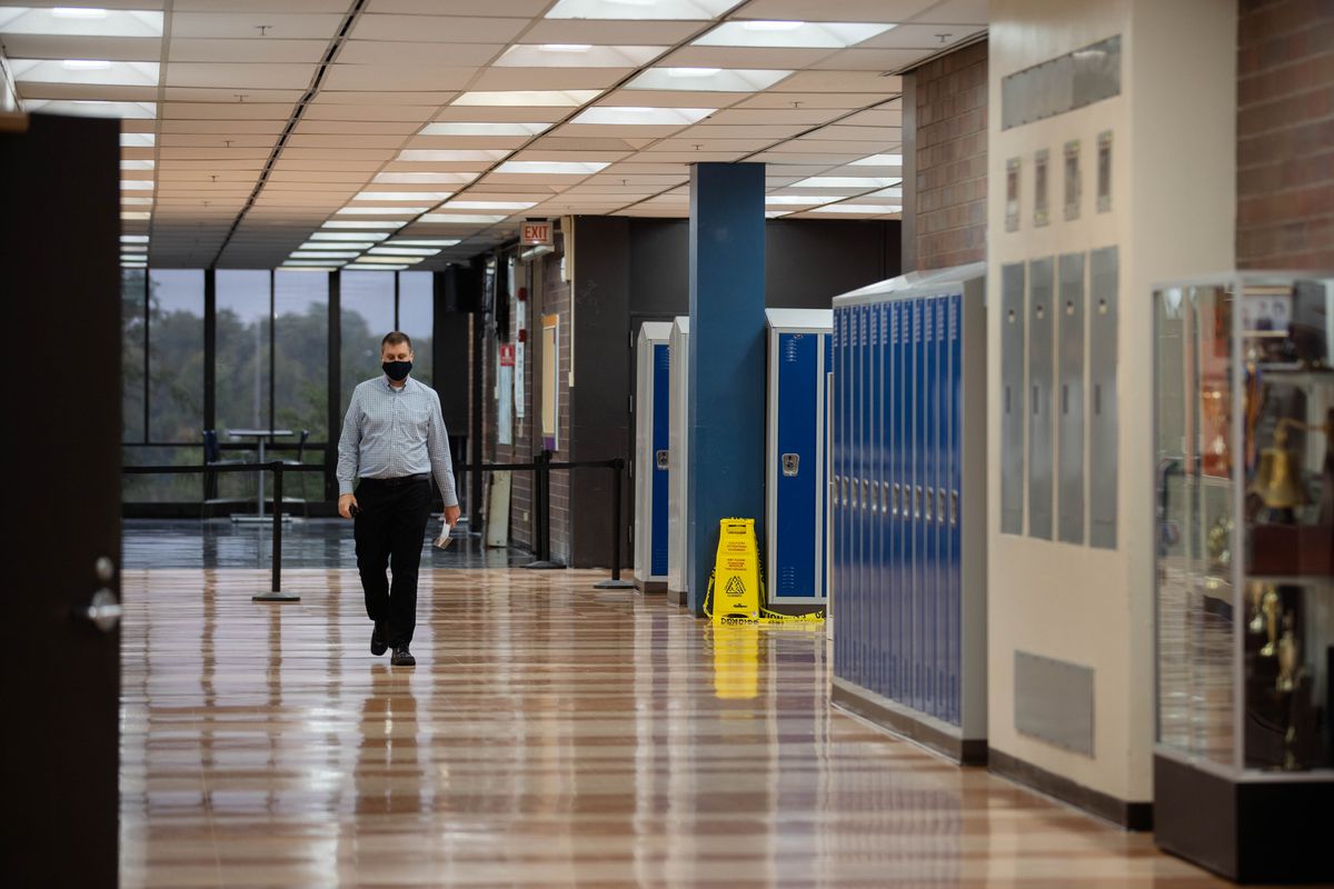 Assistant Principal Matthew Swanson walks inside Whitney M. Young Magnet High School on the first day back to school Tuesday morning, Sept. 8, 2020.