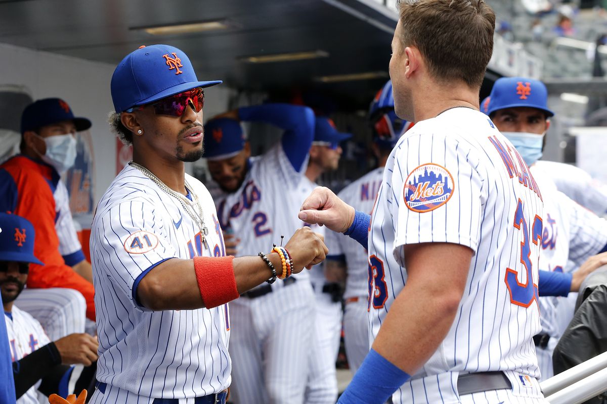 Francisco Lindor #12 and James McCann #33 of the New York Mets prepare for a game against the Miami Marlins at Citi Field on April 10, 2021 in New York City. The Marlins defeated the Mets 3-0.