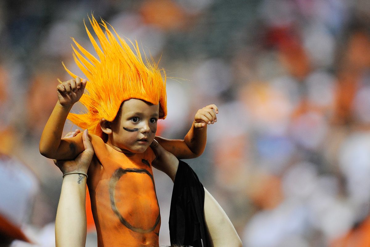 BALTIMORE, MD - JULY 27: A young fan celebrates during a game between the Oakland Athletics and Baltimore Orioles at Oriole Park at Camden Yards on July 27, 2012 in Baltimore, Maryland. (Photo by Patrick McDermott/Getty Images)