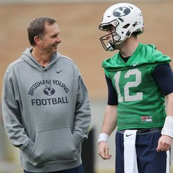 Brigham Young Cougars  coach Ty Detmer  talks with Brigham Young Cougars quarterback Tanner Mangum (12)  during practice in Provo Tuesday, March 1, 2016. 