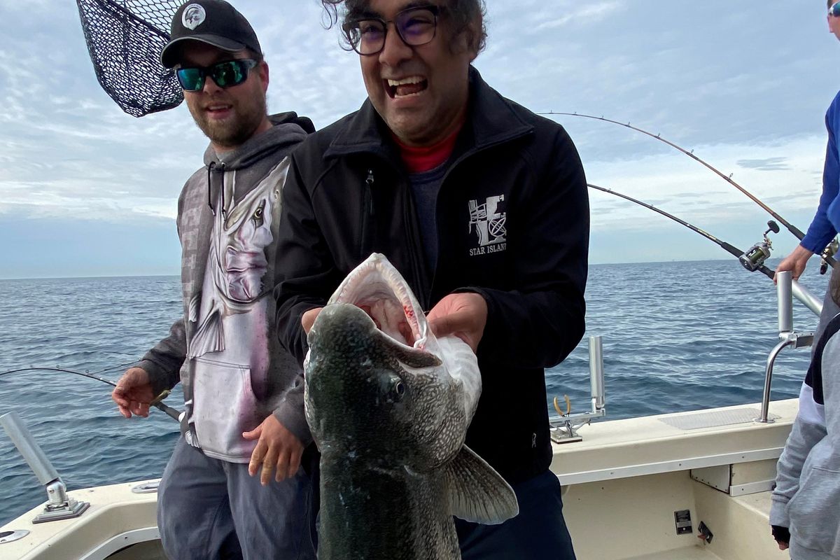 Dr. Atul Mallik caught the Illinois record for lake trout on May 31, 2021 (mate Gregg Peters laughs in the background. Provided photo