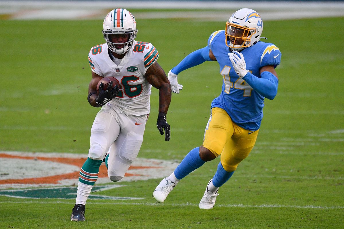 Salvon Ahmed #26 of the Miami Dolphins runs with the ball against the Los Angeles Chargers at Hard Rock Stadium on November 15, 2020 in Miami Gardens, Florida.