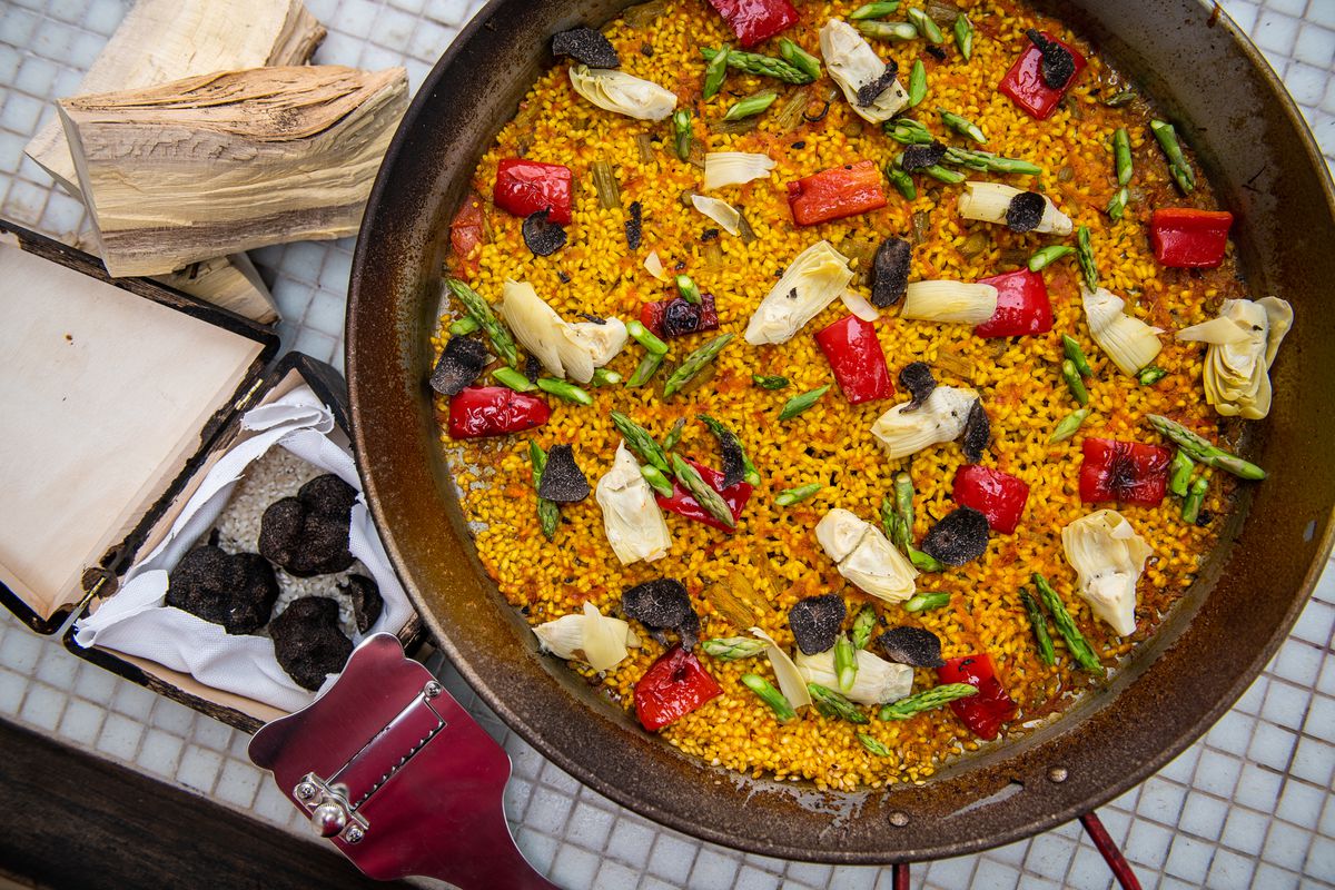 Vegan paella gets cooked over orange wood fire at Xiquet