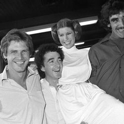 FILE - In this Oct. 5, 1978 photo, from left, actors Harrison Ford, Anthony Daniels, Carrie Fisher and Peter Mayhew take a break from filming a television special in Los Angeles to be telecast during the holidays. On Tuesday, Dec. 27, 2016, a publicist says Fisher has died at the age of 60. 