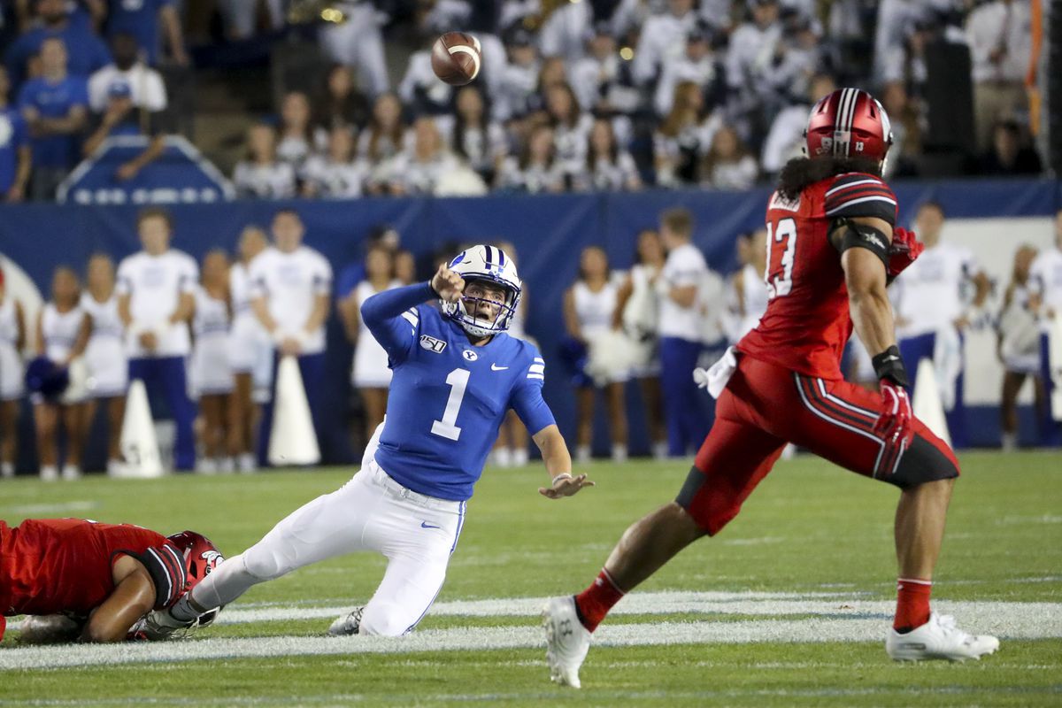 Brigham Young Cougars quarterback Zach Wilson (1) gets dragged down as he tries to throw a pass that is intercepted Utah Utes linebacker Francis Bernard, who ran it back for a touchdown during the University of Utah at BYU football game at LaVell Edwards Stadium in Provo on Thursday, Aug. 29, 2019