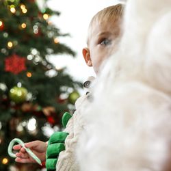 Daschle Johnson, 2, sits with Santa Claus at the Sugar House Santa Shack in Salt Lake City on Saturday, Nov. 26, 2016.