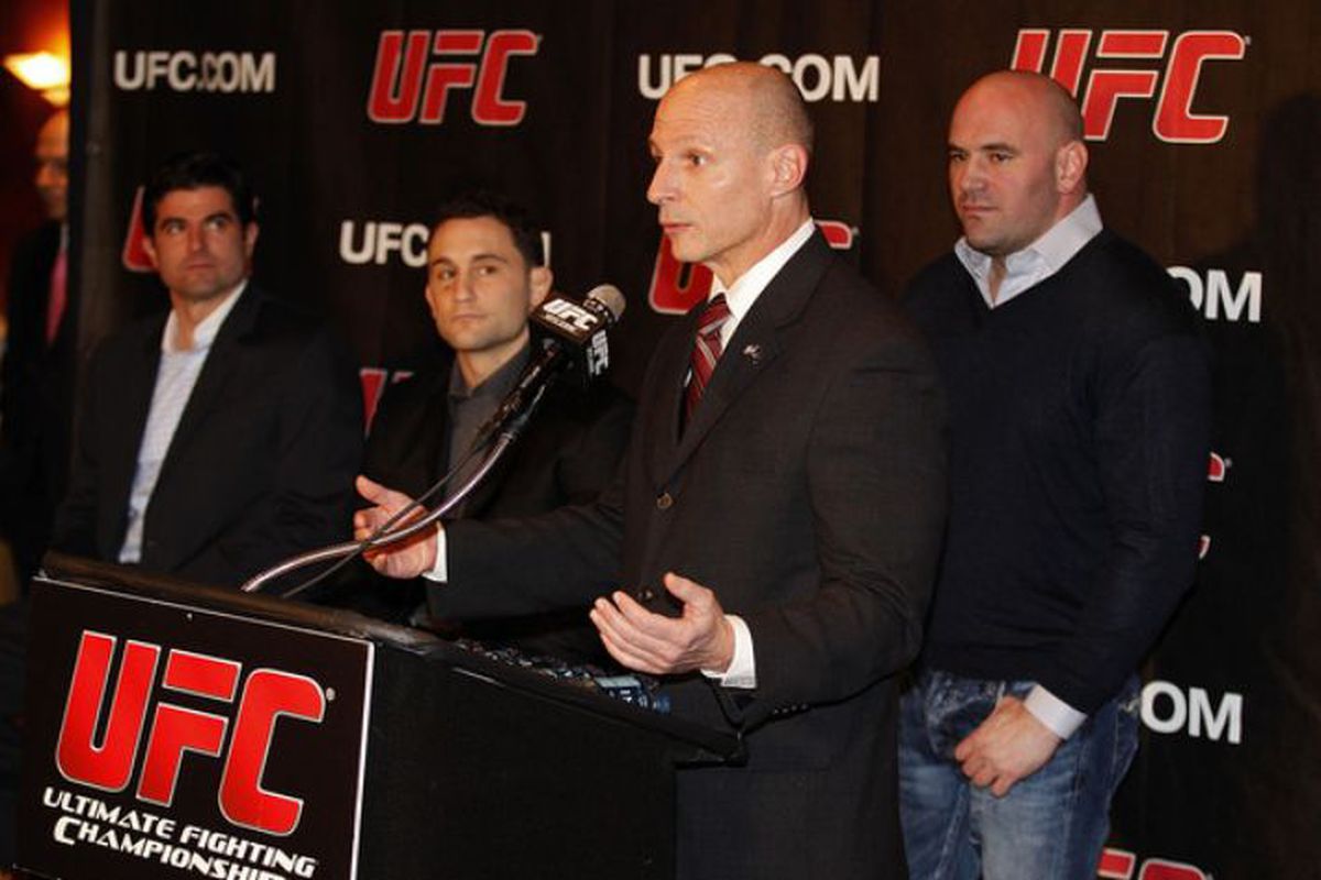 Dean Murray, New York State assemblyman, speaks at the podium as Scott O'Neil, Frankie Edgar and Dana White (L-R) look on during a 2013 press conference to announce commitment to bring UFC to Madison Square Garden and New York State.