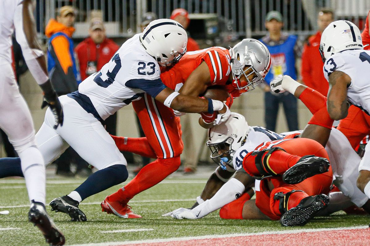 Ohio State Buckeyes running back TreVeyon Henderson (32) scores a touchdown past Penn State Nittany Lions linebacker Curtis Jacobs (23) during the third quarter of the NCAA football game at Ohio Stadium in Columbus on Sunday, Oct. 31, 2021.