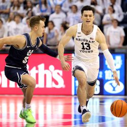 Brigham Young Cougars guard Alex Barcello (13) brings the ball up court with Utah State Aggies guard Steven Ashworth (3) defending as BYU and Utah State play an NCAA basketball game in Provo at the Marriott Center on Wednesday, Dec. 8, 2021. BYU won 82-71.