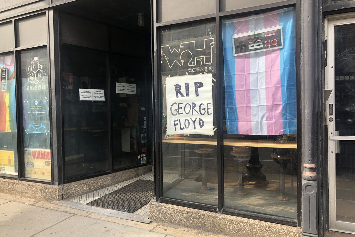 A storefront of a coffee shop with a sign that reads “RIP George Floyd.”