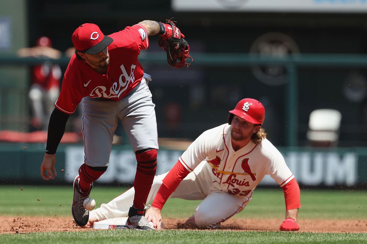 Jonathan India #6 of the Cincinnati Reds attempts to field a ground ball as Brendan Donovan #33 of the St. Louis Cardinals slides safely into second base in the second inning at Busch Stadium on July 16, 2022 in St Louis, Missouri.