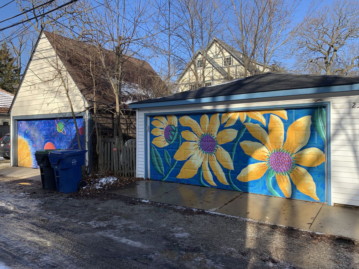 Sunflowers and the solar system are the focus of these two garage murals in Evanston done by Teresa Parod.