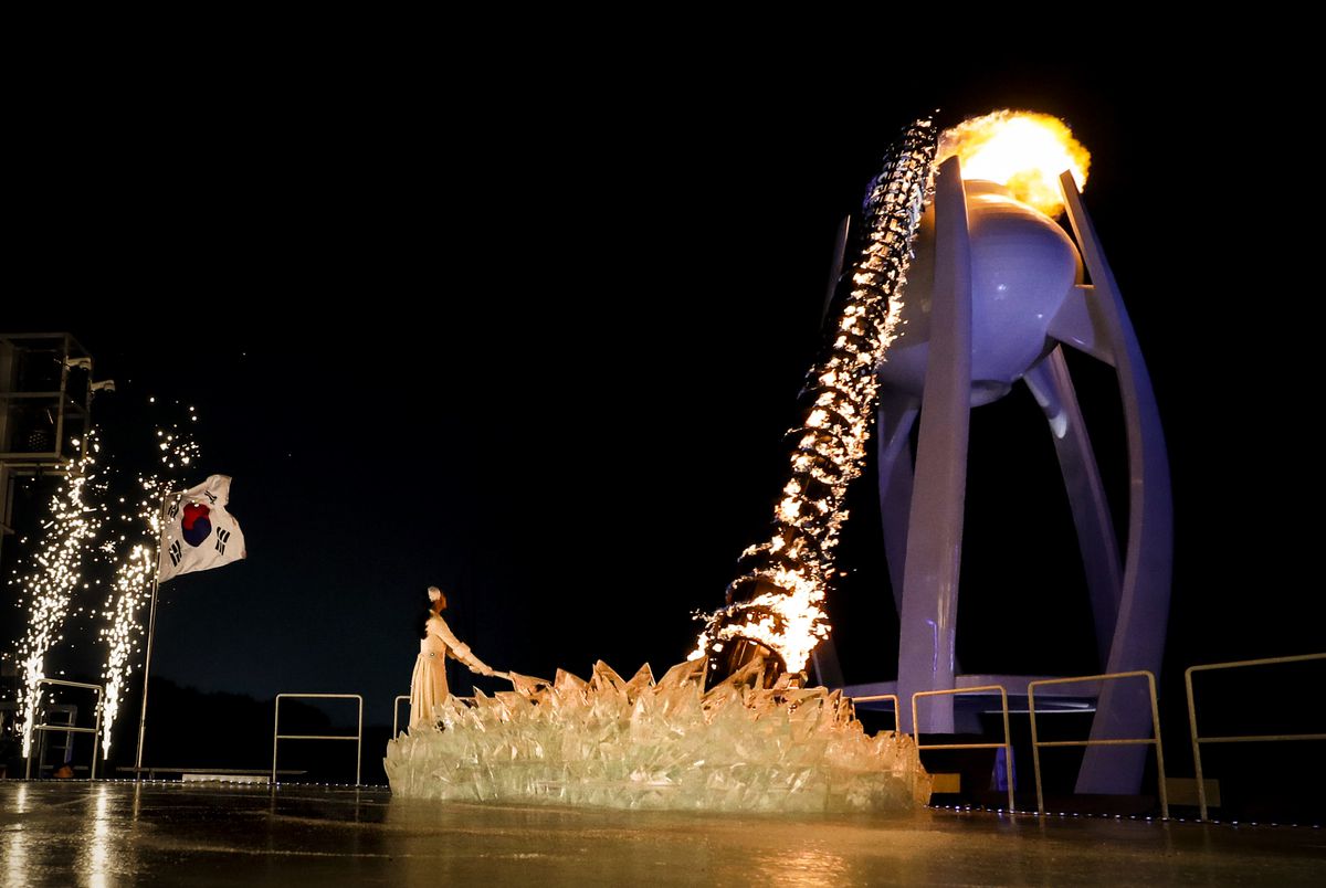 South Korean figure skater Kim Yu-na lights the cauldron.