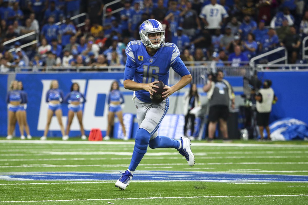 Jared Goff #16 of the Detroit Lions scrambles out of the pocket during an NFL football game against the Washington Commanders at Ford Field on September 18, 2022 in Detroit, Michigan.