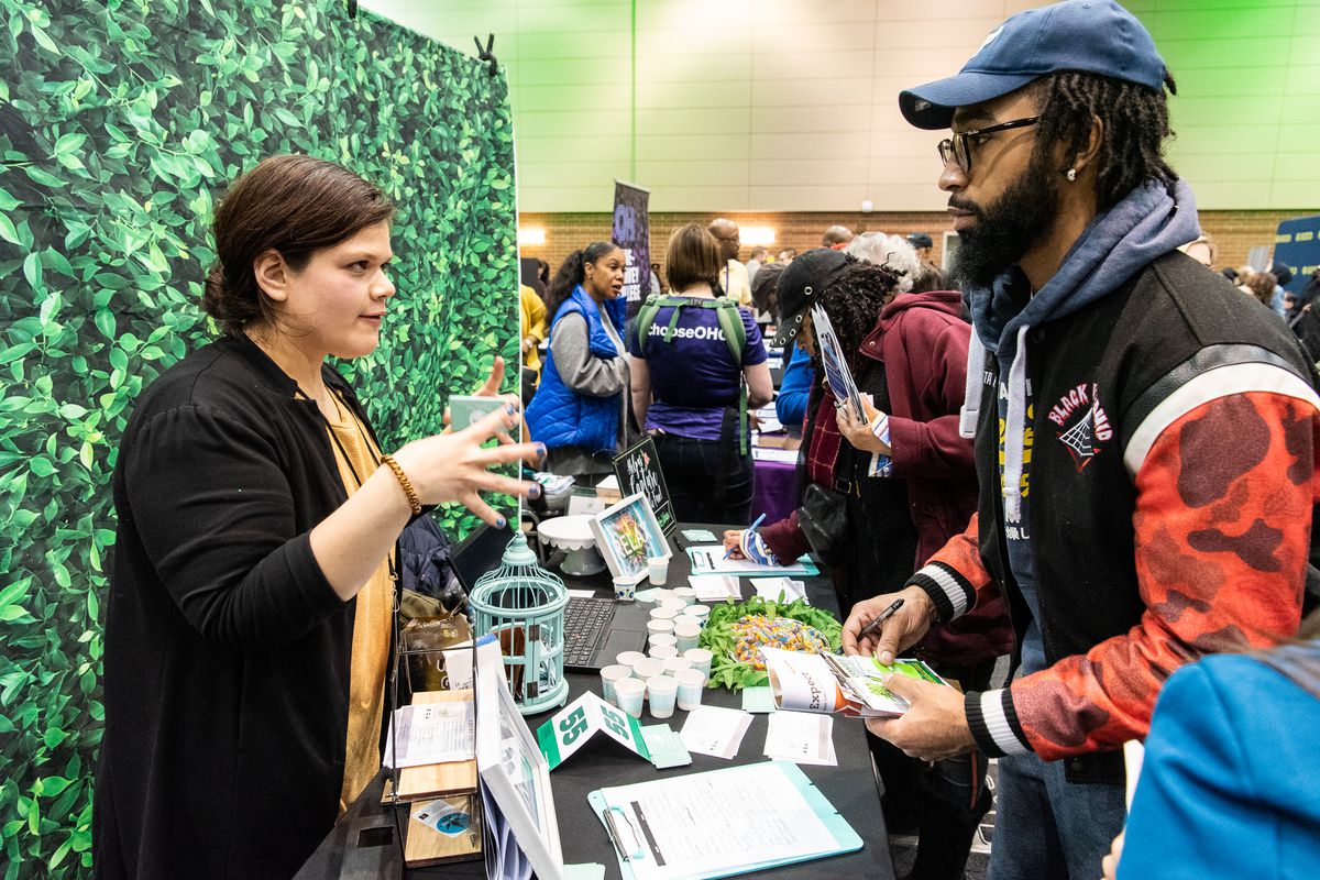 A man speaks with a representative with Elementos Verde a vendor at Chicago’s first Cannabis Resource Fair at the UIC Forum on Saturday.