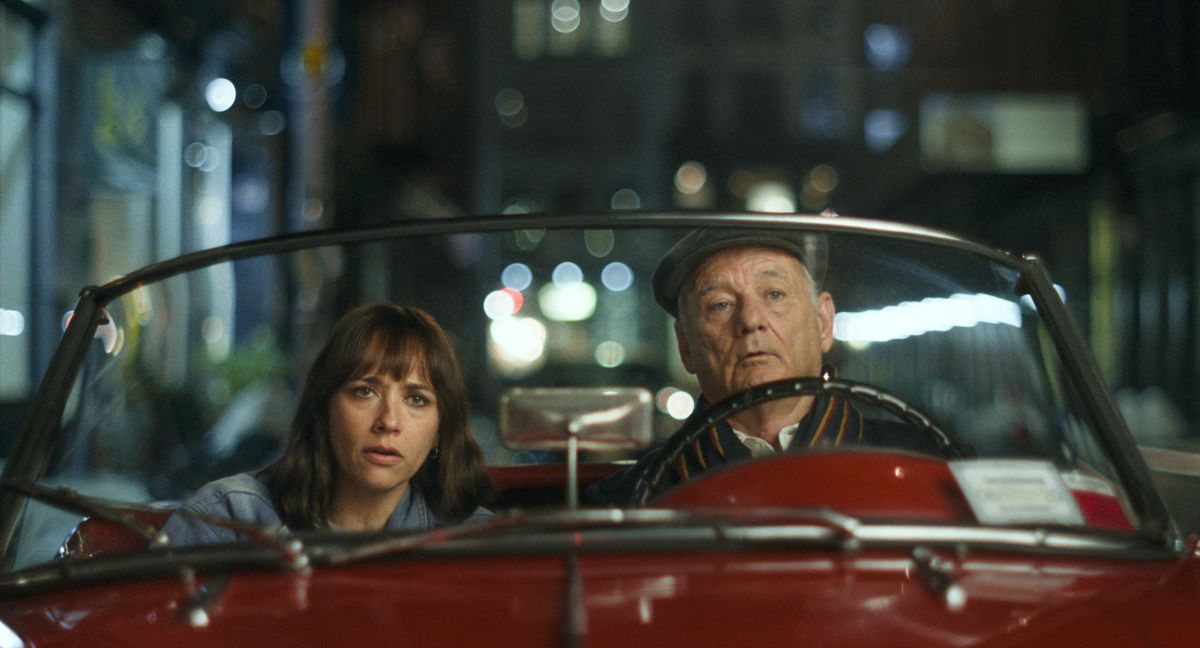 Rashida Jones and Bill Murray drive together at night in a red convertible in On the Rocks