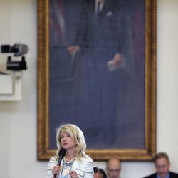 Standing in front of a portrait of President Lyndon B. Johnson, Sen. Wendy Davis, D-Fort Worth, begins a filibuster in an effort to kill an abortion bill, Tuesday, June 25, 2013, in Austin, Texas. The bill would ban abortion after 20 weeks of pregnancy and force many clinics that perform the procedure to upgrade their facilities and be classified as ambulatory surgical centers.  (AP Photo/Eric Gay)