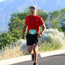 Carl Gallegos runs in the American Fork Canyon Half Marathon Saturday, June 15, 2013. Gallegos, 57, crossed the finished line in one hou,r 56 minutes. He grabbed his medal and a bottle of water before telling a volunteer he needed to find the aid station. That’s the last thing he remembers before going into cardiac arrest.