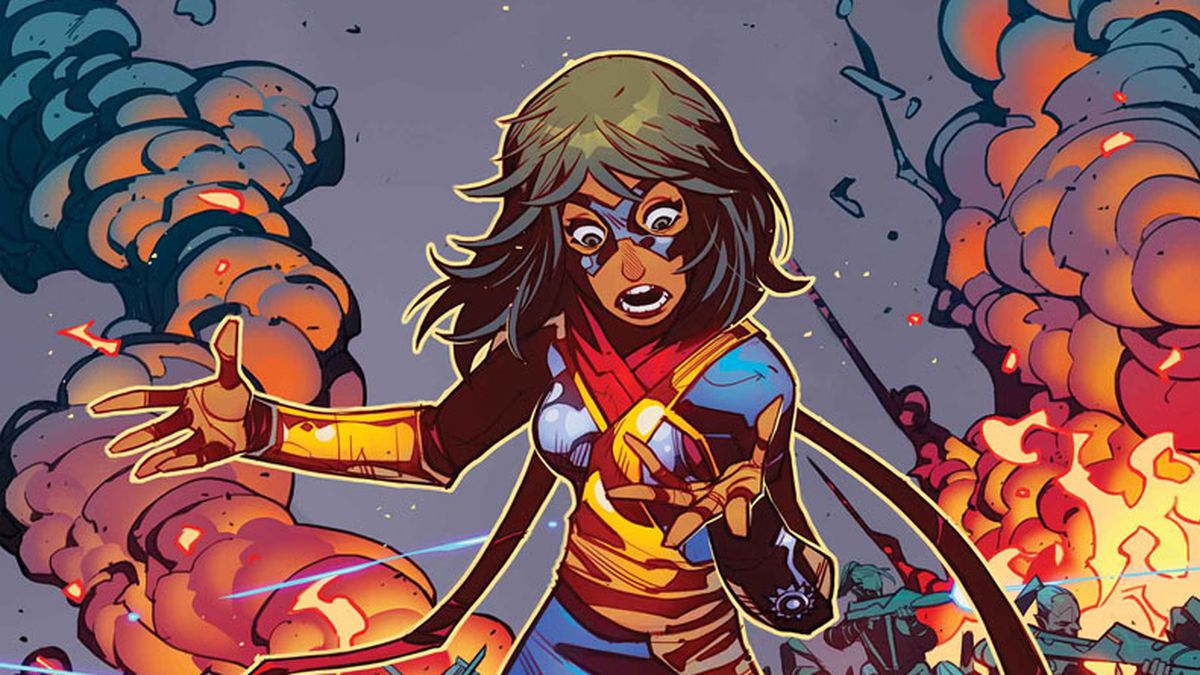 Kamala Khan/Ms. Marvel stares in surprise at her new red, blue and gold costume as she stands in the midst of an alien battlefield, on the cover of Magnificent Ms. Marvel #5, Marvel Comics (2019).