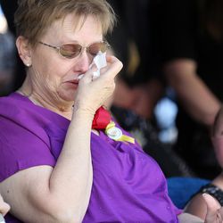 Lorie Ricks, widow of Kay Ricks, wipes away tears at funeral services at the Lehi City Cemetery in Lehi, Saturday, May 28, 2016. Ricks was a UTA employee who vanished while on the job and was found dead in Wyoming on May 17.