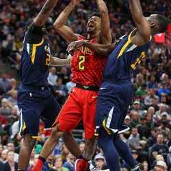 Atlanta Hawks guard Tyler Dorsey (2) goes to the hoop against Utah Jazz forward Royce O'Neale (23) and center Ekpe Udoh (33) during the game at Vivint Smart Home Arena in Salt Lake City on Tuesday, March 20, 2018.