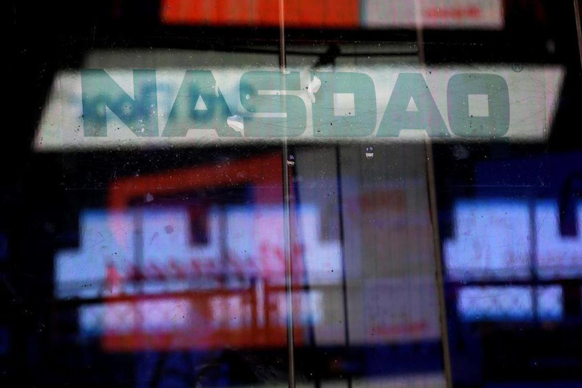 FILE - In this Thursday, Aug. 22, 2013, file photo, electronic billboards are reflected in the windows of Nasdaq in New York. The Nasdaq composite rose for an eighth straight day Friday, Feb. 20, 2015, pushing the index closer to its all-time closing high
