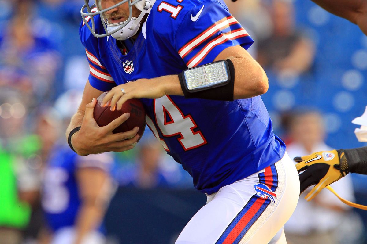 Aug 9, 2012; Orchard Park, NY, USA; Buffalo Bills quarterback Ryan Fitzpatrick (14) runs with the ball against the Washington Redskins during the first quarter at the Ralph Wilson Stadium. Mandatory Credit: Kevin Hoffman-US PRESSWIRE
